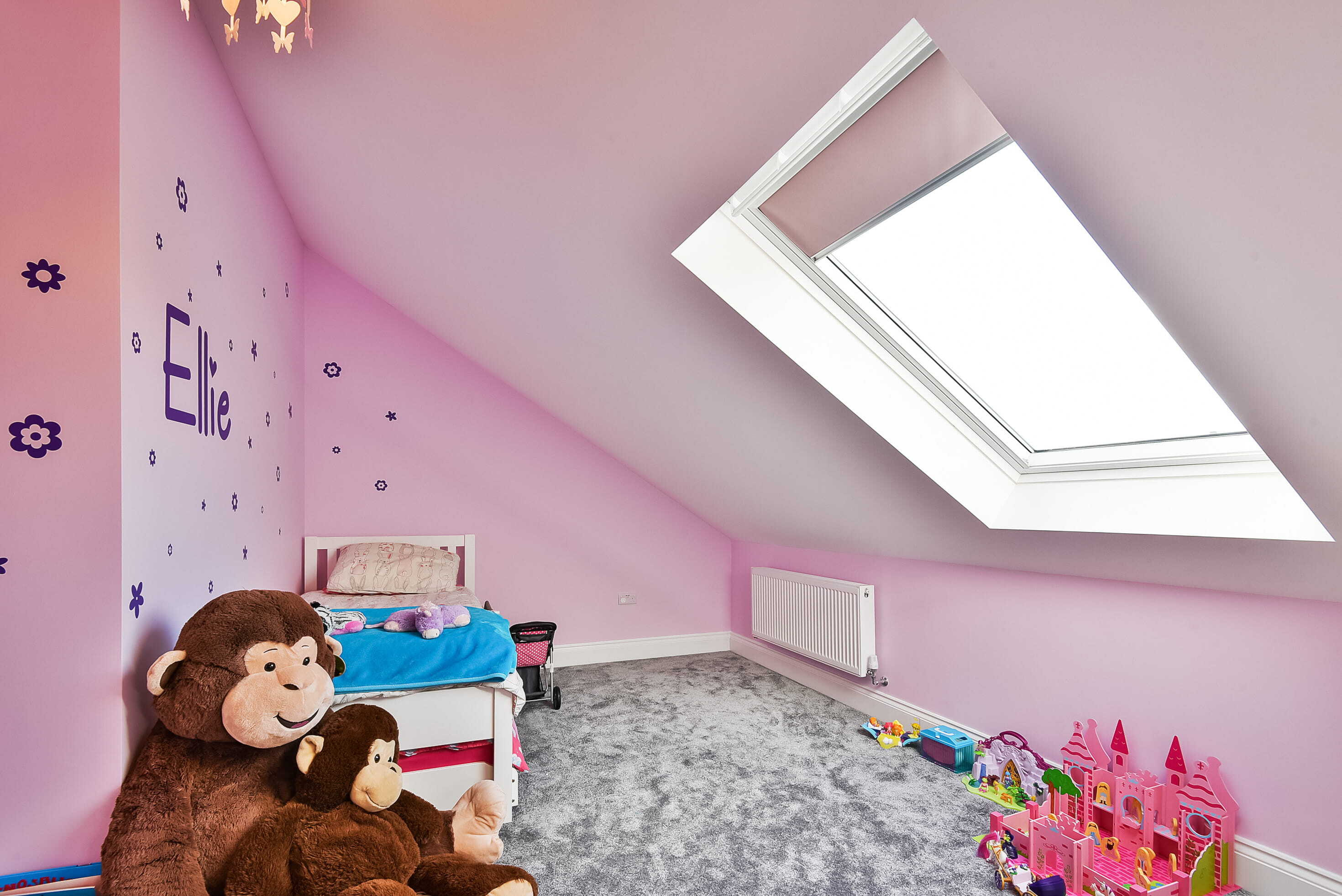 A loft conversion which had been planned in advance to turn it into a pink girls' room, for the latest daughter of a couple.