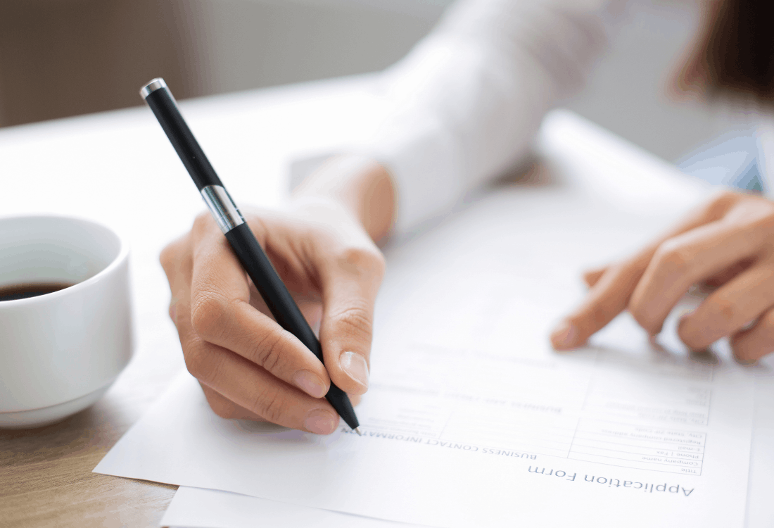 A woman filling out a household planning application form.